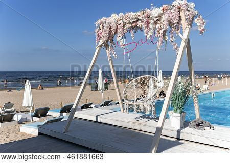 Latvia, Jurmala, August, 2022 - People Enjoying Relaxing On The Baltic Sea Beach In Jurmala, Latvia.
