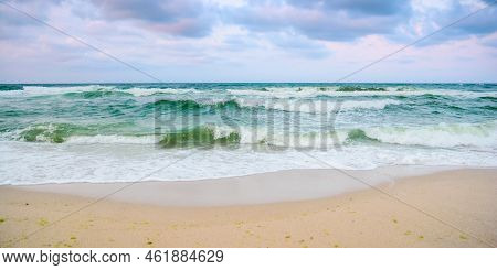 Sandy Beach Before The Storm. Evening Scenery With Heavy Clouds In Colorful Light. Turquoise Waves R