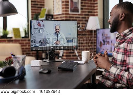 Male Freelancer Chatting With Medic On Telemedicine Videocall Conference, Using Online Telehealth Vi