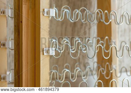 View Of Spring Shock Absorbers Stretched On A Frame Inside A Modern Soft Sofa.