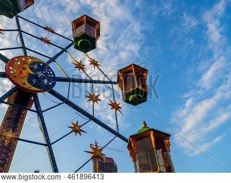 A Small Ferris Wheel In The Park. A Bright Attraction For Children. Entertainment In The Park. Color