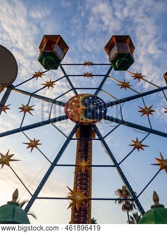 A Small Ferris Wheel In The Park. A Bright Attraction For Children. Entertainment In The Park. Color
