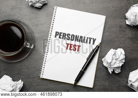 Notebook With Text Personality Test, Pen And Crumpled Sheets Of Paper On Grey Table, Flat Lay