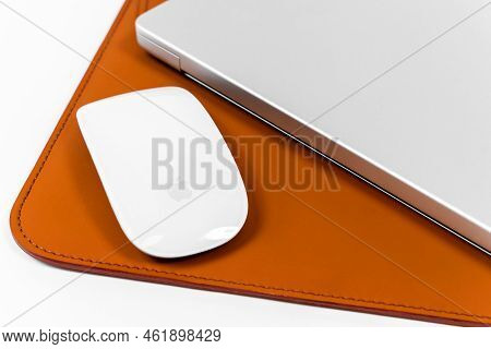 Rostov, Russia - April 04, 2022: Apple Magic Mouse, Laptop Apple Macbook Pro Lie Handmade Leather Re