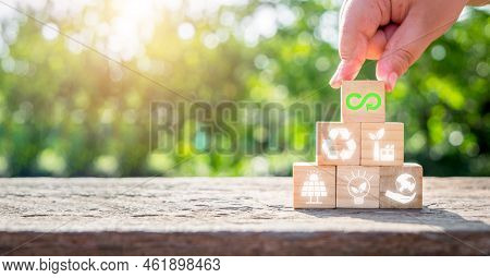 Circular Economy Concept, Man Hand Holding Wooden Cube Block With Circular Economy Icon With Copy Sp