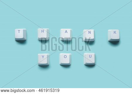 Word Thank You Written On Computer Keyboard Keys Isolated On A Turquoise Background.