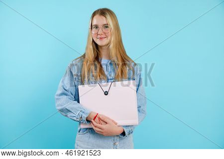 Confident, Powerful, Smiling Blonde Teenage Girl In Glasses Holding Paper Folder, Portfolio. Back To