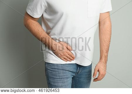 Man Suffering From Acute Appendicitis On Light Grey Background, Closeup