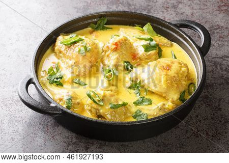Kuku Paka Kenyan Chicken In Coconut Curry Sauce Closeup In The Pan On The Table. Horizontal