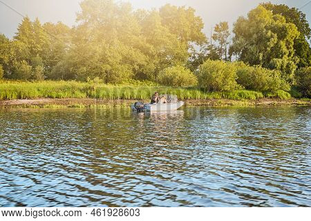 Summer Travel Destinations. The Pripyat River With Fishing Boat With Two Fishermans Resting Along Th