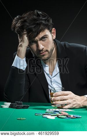 Sad Frustrated Handsome Caucasian Brunet Young Pocker Player At Pocker Table With Chips And Cards Wh