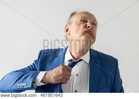 Portrait Of Stressed Mature Businessman Suffocating With Necktie. Senior Manager Wearing Formalwear 