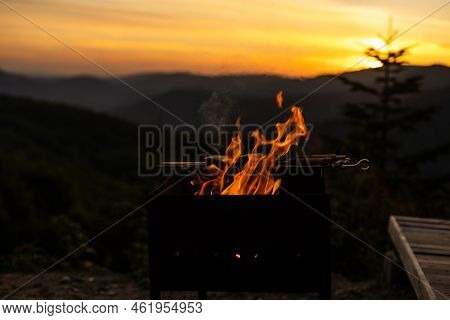 Burning Wood At Night. Campfire At Touristic Camp At Nature In Mountains. Flame Amd Fire Sparks On D