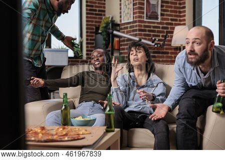 Competitive Group Of Friends Losing Video Games Play On Television Console, Feeling Sad And Frustrat