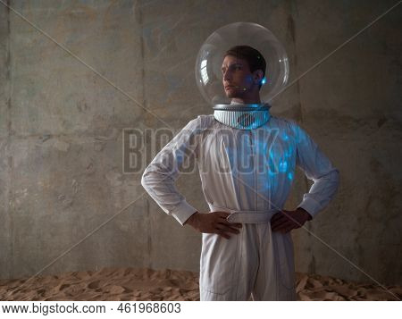 Heroic Astronaut In A Retrofuturism-style Spacesuit On A Desert Planet, A Hologram Of Star Systems O