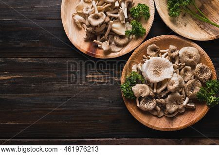 Fresh Edible Mushroom In Natural Plate On Wooden Background, Organic Food Ingredients In Seasonal