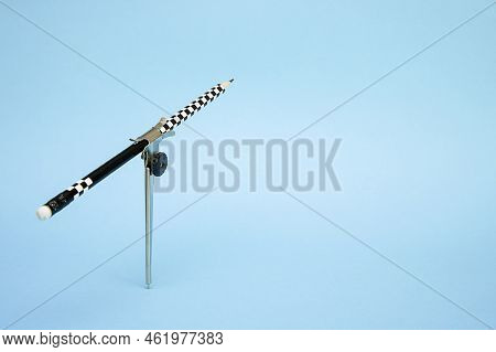 Compass With A Pencil Raised Up On A Blue Background With Copy Space