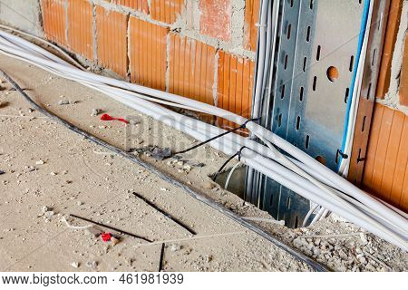Metal Perforated Tray With Bundle Of Insulated Cables Passes Between Floors Through A Floor Quadrati