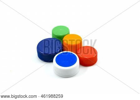 Colorful Plastic Bottle Caps Including Recyclable Materials Isolated On A White Background.