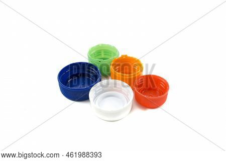 Colorful Plastic Bottle Caps Including Recyclable Materials Isolated On A White Background.