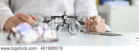 Glasses For Checking Vision Lying On Table Near Doctor Ophthalmologist Closeup. Correction Of Myopia