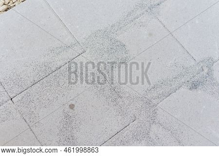 Polymeric Paver Sand On Top Of Gray Concrete Patio Stone Paver Brick Walkway In Texas, Usa