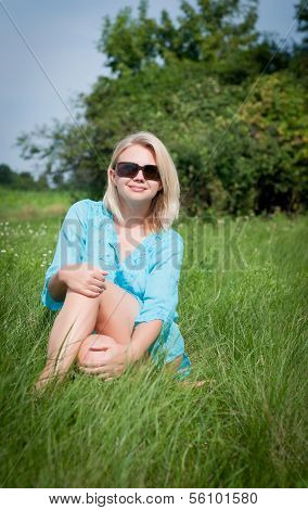 Attractive happy woman in the meadow