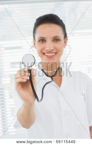 Portrait of a smiling female doctor with stethoscope in a bright hospital