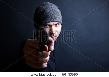 Portrait of a man holding gun