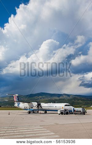 SPLIT, CROATIA - JUN 6: Croatia Airlines Dash 8 Q400 parked on a runway of Split Airport during boarding on June 6, 2013 in Split, Croatia. Airport has very good connections to other European cities.
