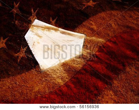 Home plate on baseball field with American Flag over