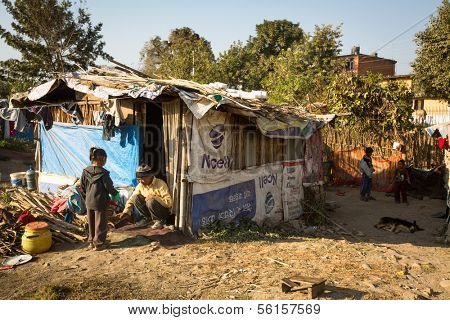 KATHMANDU, NEPAL - DEC 16: Unidentified poor people near their houses at slums in Tripureshwor district, Dec 16, 2013 in Kathmandu, Nepal. Caste of untouchables in Nepal, is about 7 % of population.