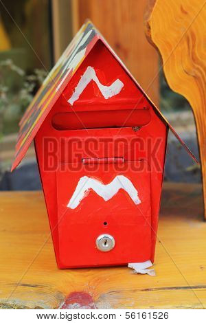 Red Postbox On The Wooden Floor.