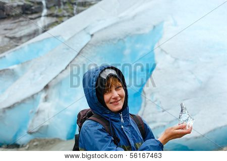 Woman With Ice Piece Near Nigardsbreen Glacier (norway)