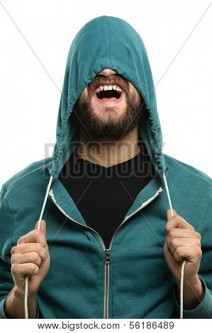 Young man with beard pulling hood over head isolated over white background