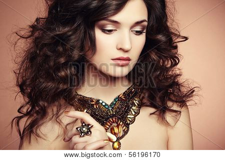 Portrait Of Beautiful Brunette Woman With Earring. Perfect Makeup