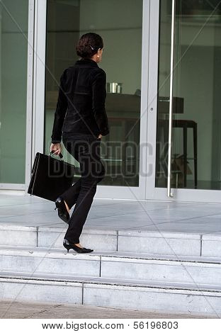 An attractive young woman on her way to work.