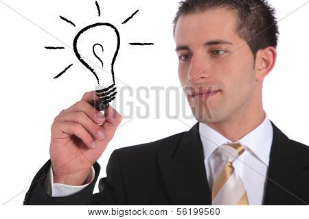 A handsome businessman sketching a lightbulb. All on white background.