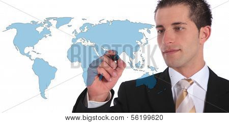A handsome businessman presenting concepts of global market expansion. All on white background.
