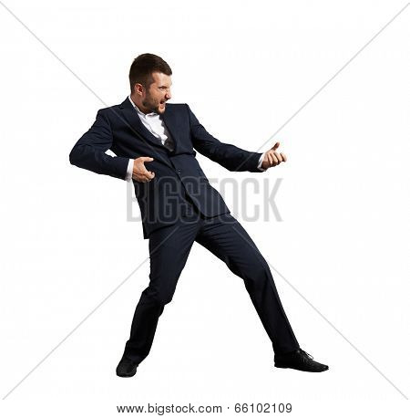 screaming businessman pulling invisible rope. isolated on white background