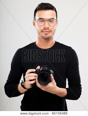 Portrait of a photographer holding a reflex camera