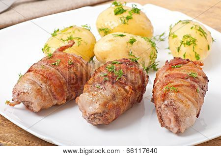 Grilled meat rolls wrapped in strips of bacon