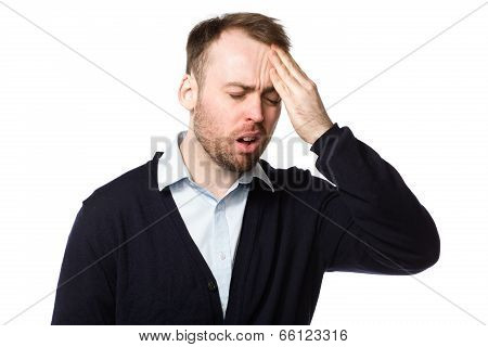 Man Rubbing His Throbbing Forehead With His Hand