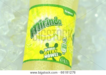 Bottle of Mirinda drink on ice cubes