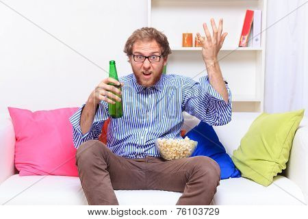 Dissatisfacted Man On The Couch When Watching Tv