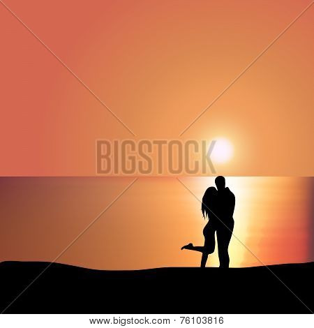 Loving couple on the seashore at sunset