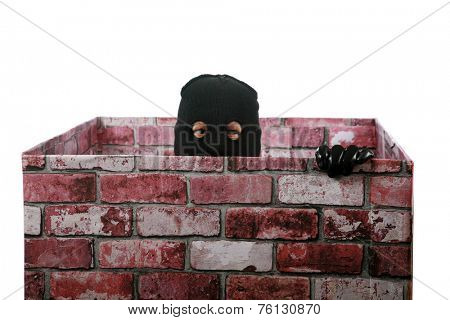 A genuine Bad Guy aka Burglar pops his head out of a chimney looking to see if the coast is clear for his escape after robbing money and valuables from a persons home. Burglars are cowardly thief's 