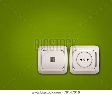 Computer And Electrical Outlets On Green Wall