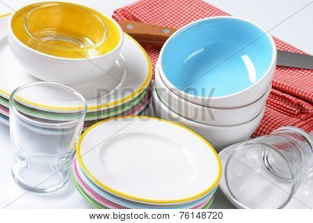 detail of porcelain cookware - plates, bowls and knife with fabric linen