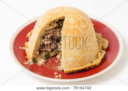 Chicken and mushroom suet pudding, steamed in a a basin, and old-fashioned English speciality